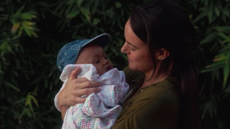 Sarah Butler holding baby in "Doubting Thomas