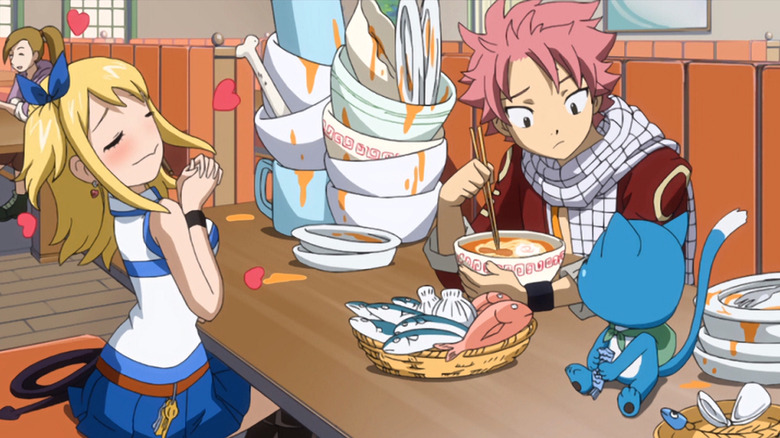 Happy, Lucy, and Natsu finishing their food