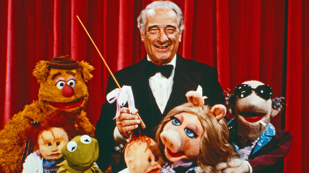 Conductor and muppets smiling