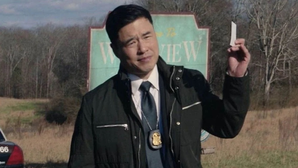 Agent Woo holding card