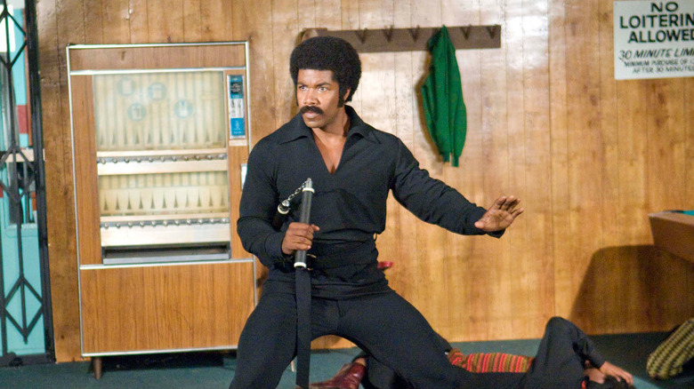 Black Dynamite holding nunchucks