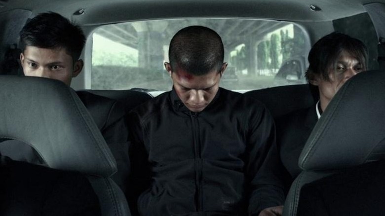 Iko Uwais in back of car