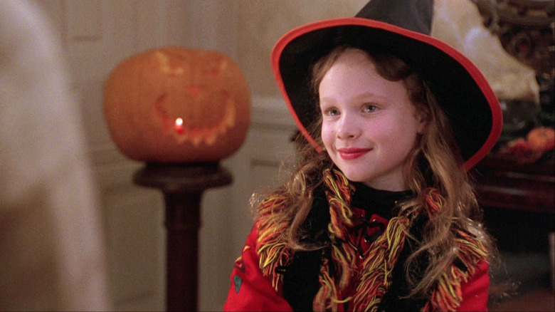 Dani Dennison smiling in a witch costume