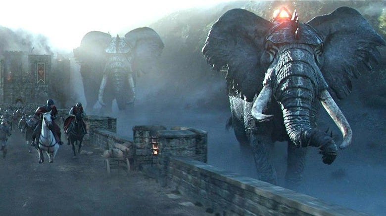 King Arthur running with fantasy elephants