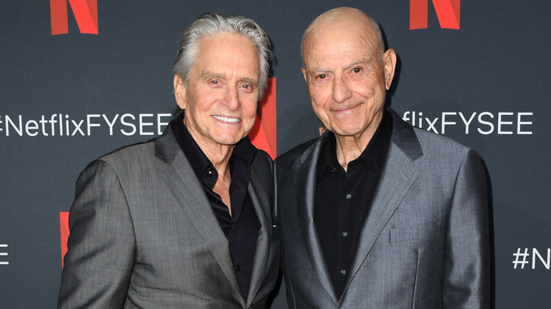 Michael Douglas and Alan Arkin at event smiling