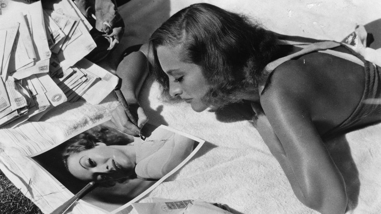 Joan Crawford signs her name to her own photo