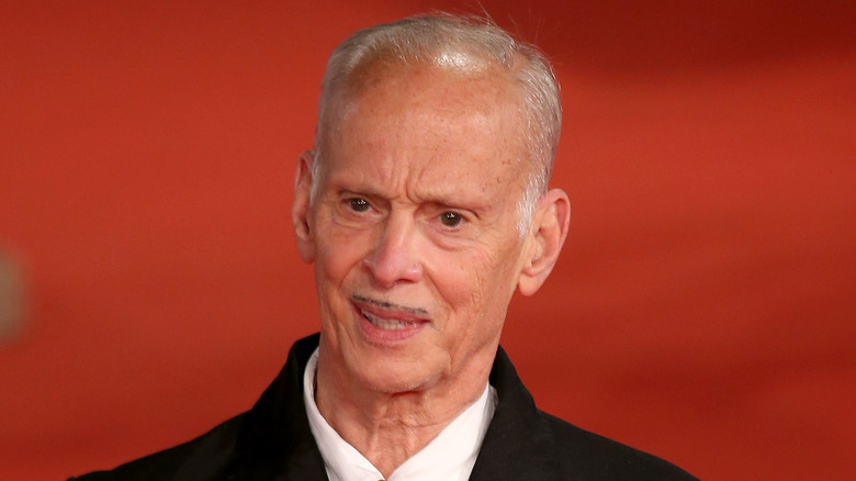 John Waters wears a coat