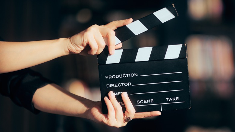 Hands hold a film slate