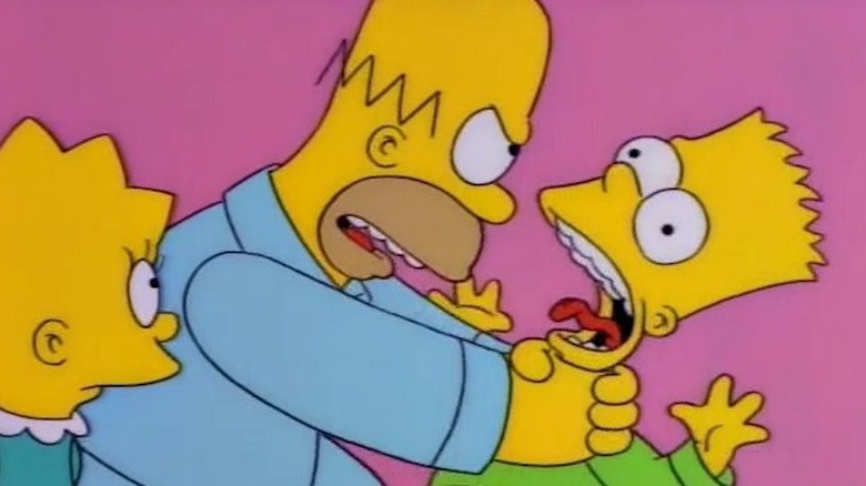 Homer Simpson chokes Bart while Lisa watches