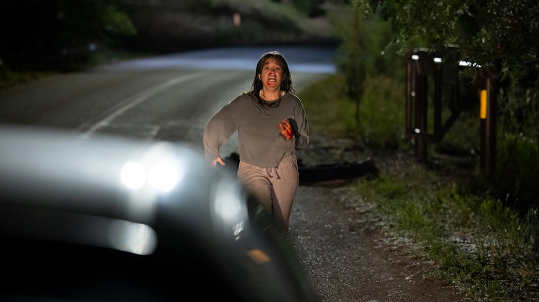 Woman running toward car