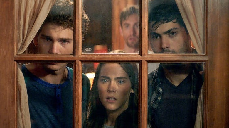 Actors look through a window