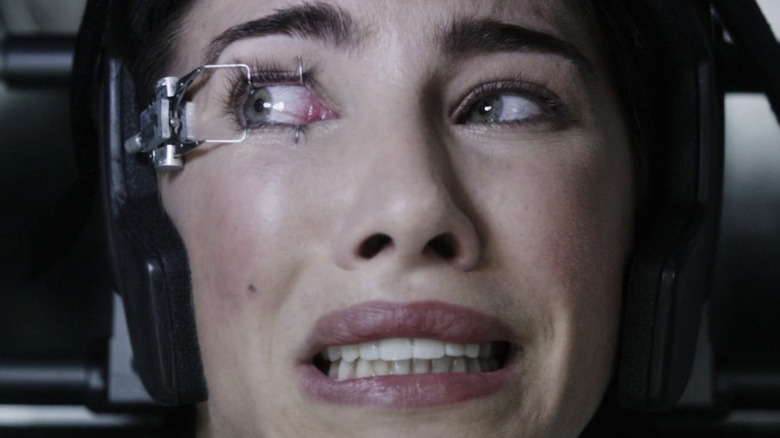 Terrified Olivia with machine on eyeball