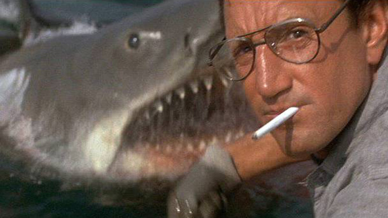 Shark popping out of water behind Roy Scheider