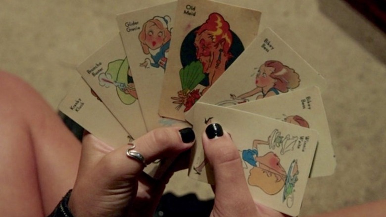 Hands holding Old Maid cards