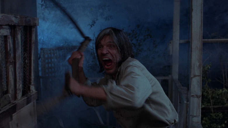 Jud wields a scythe in "Eaten Alive" (1976)