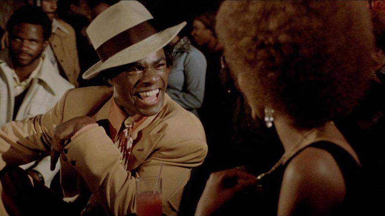 Isaac, dressed as J.D. Walker, laughs in "J.D.'s Revenge" (1976)