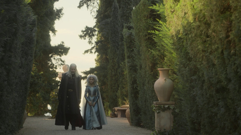 Viserys Targaryen and Leana Velaryon walk together through a garden