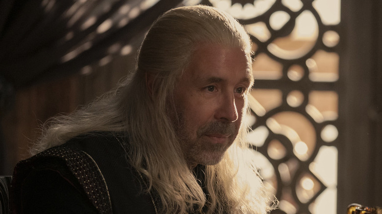 Paddy Considine as King Viserys sitting on chair