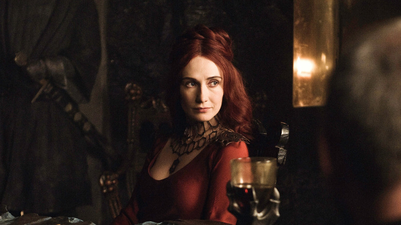 Melisandre sitting at a table