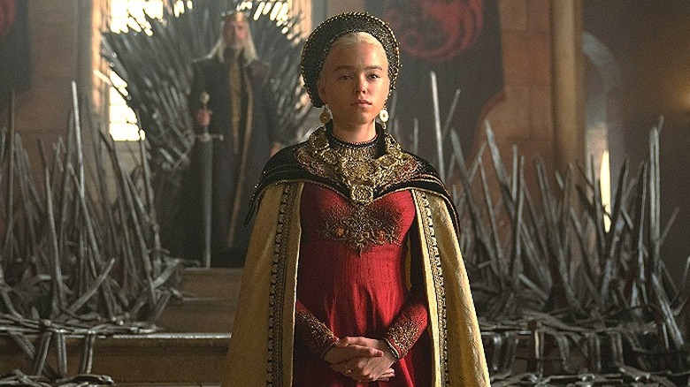 Young Rhaenyra standing in front of the Iron Throne