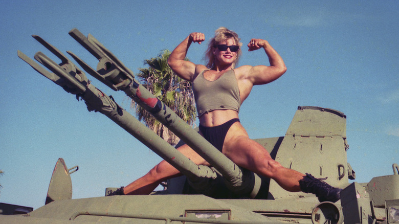 Sally posing on a tank 