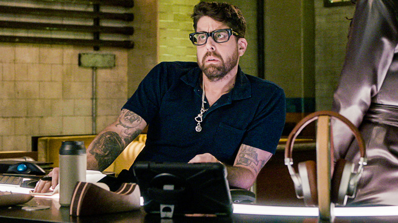 Adam Goldberg as Harry Keshegian working at desk on The Equalizer 