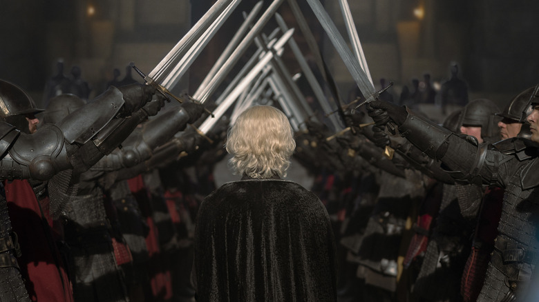 Aegon Targaryen from the back, walking through a tunnel of knights