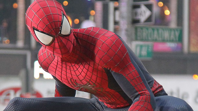 Spider-Man crouched on car