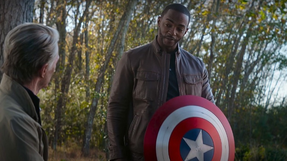 Anthony Mackie holds Cap's shield in Avengers: Endgame; Chris Evans as aged Steve Rogers