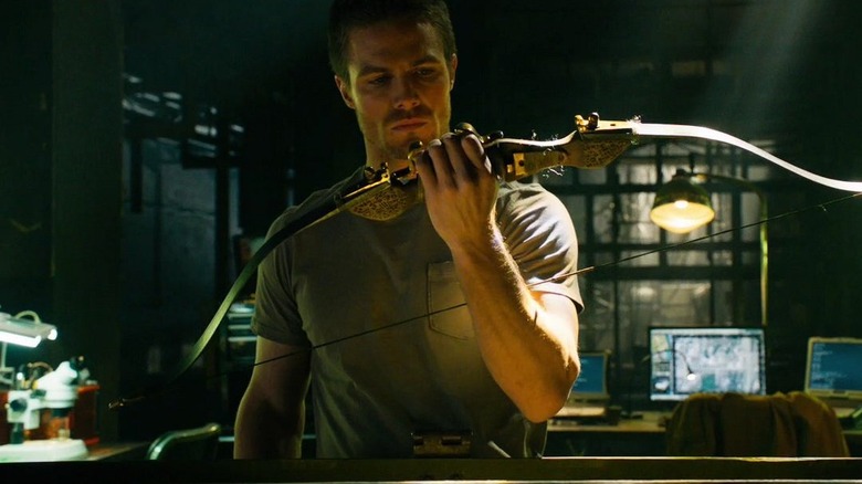 Oliver Queen examining bow