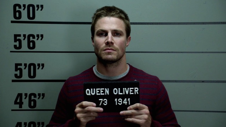 Oliver Queen taking mugshot