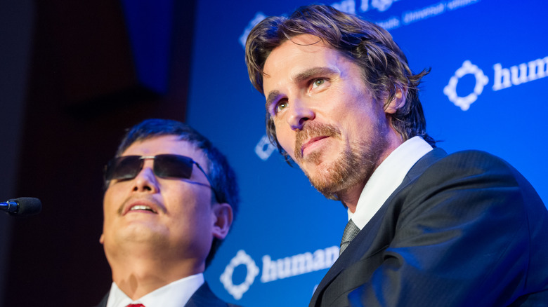 Christian Bale standing beside Chen Guangcheng