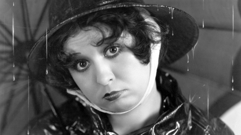 Helen Kane under umbrella pouting