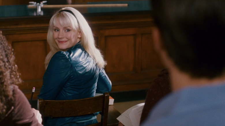 Gwen Stacy glancing behind to smile at Peter Parker