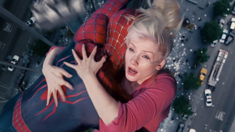 Gwen Stacy hanging onto swinging Spider-Man