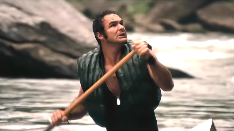 Lewis paddles down a river