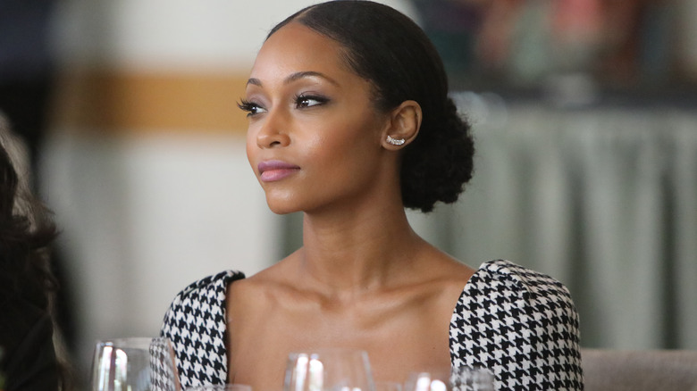 Yaya DaCosta sitting down at table