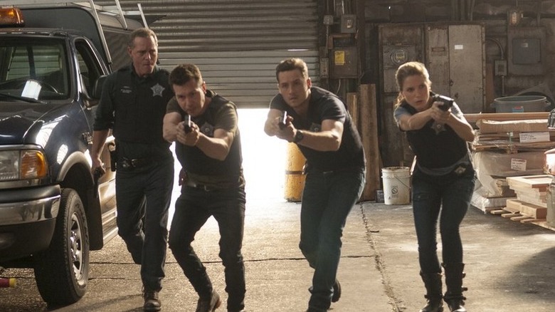 Voight commands his police officers during a raid