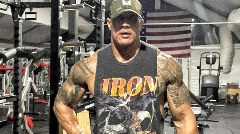 Dwayne Johnson in gym flexing muscles