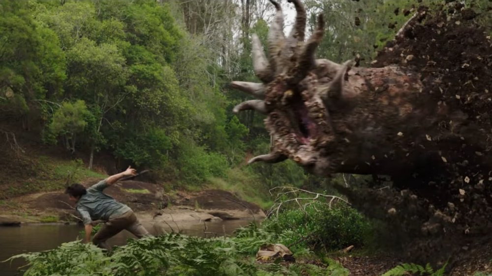 Joel (Dylan O'Brien) running from a monster in Love and Monsters