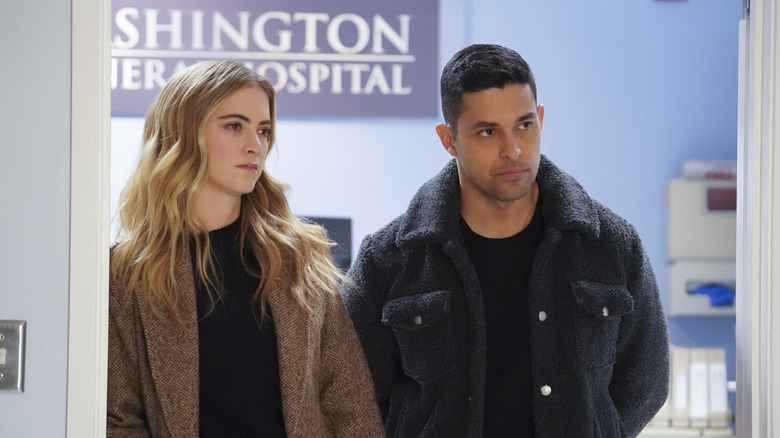 Bishop and Torres standing outside a hospital room