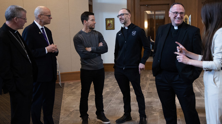 Mark Wahlberg conferring with priests at the Father Stu premiere