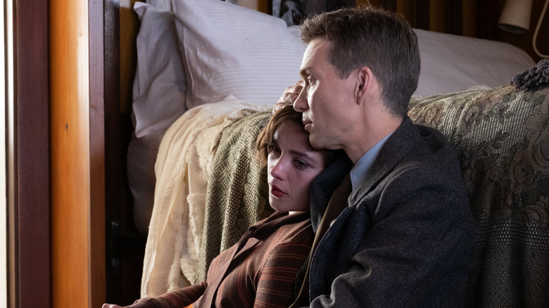 Robert and Jean sitting together besides bed