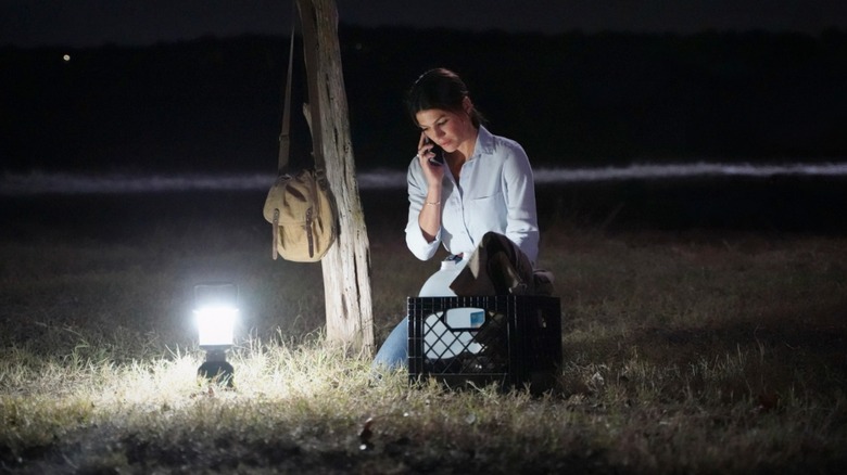 Genevieve Padalecki holds a phone in the dark