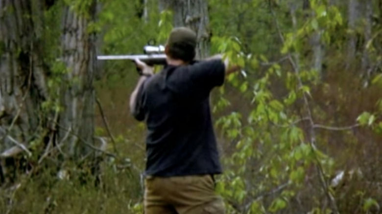 Gold Rush miner shooting a black bear