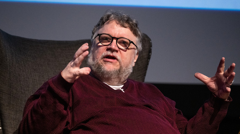 Guillermo del Toro sits in chair