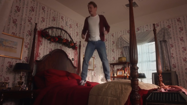 Adult Kevin McCallister jumping on the bed