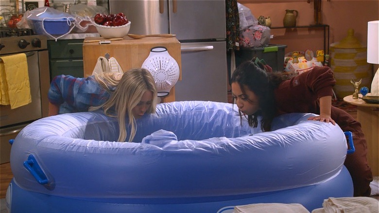 Sophie leaning over inflatable pool 