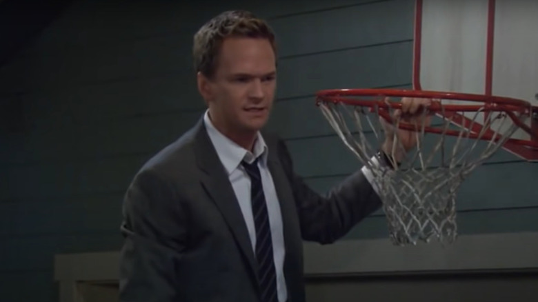 Barney holding a basketball hoop