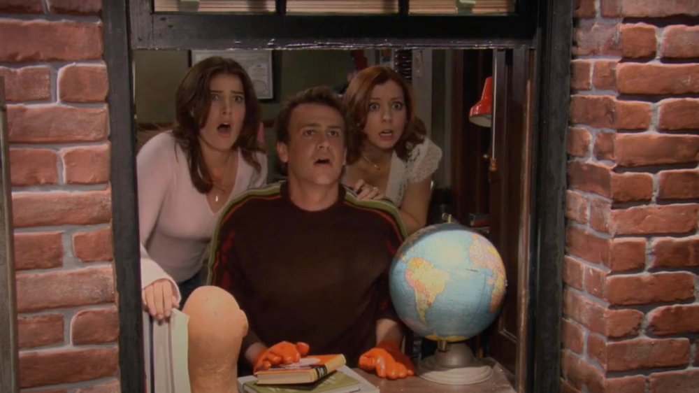 Cobie Smulders as Robin Scherbatsky, Alyson Hannigan as Lily Aldrin, and Jason Segel as Marshall Eriksen in How I Met Your Mother